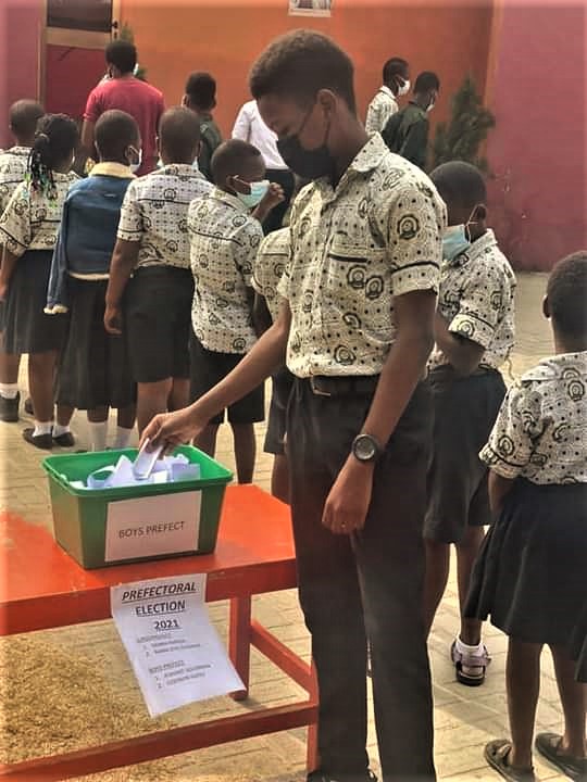 A student casting his vote during the election