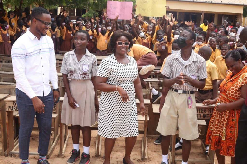 Excited students smile with Mr Precious Senafiawo