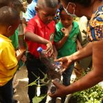 students and teachers embarking on a tree planting exercise