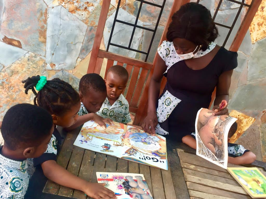 a facilitator giving children instructions using TLMs